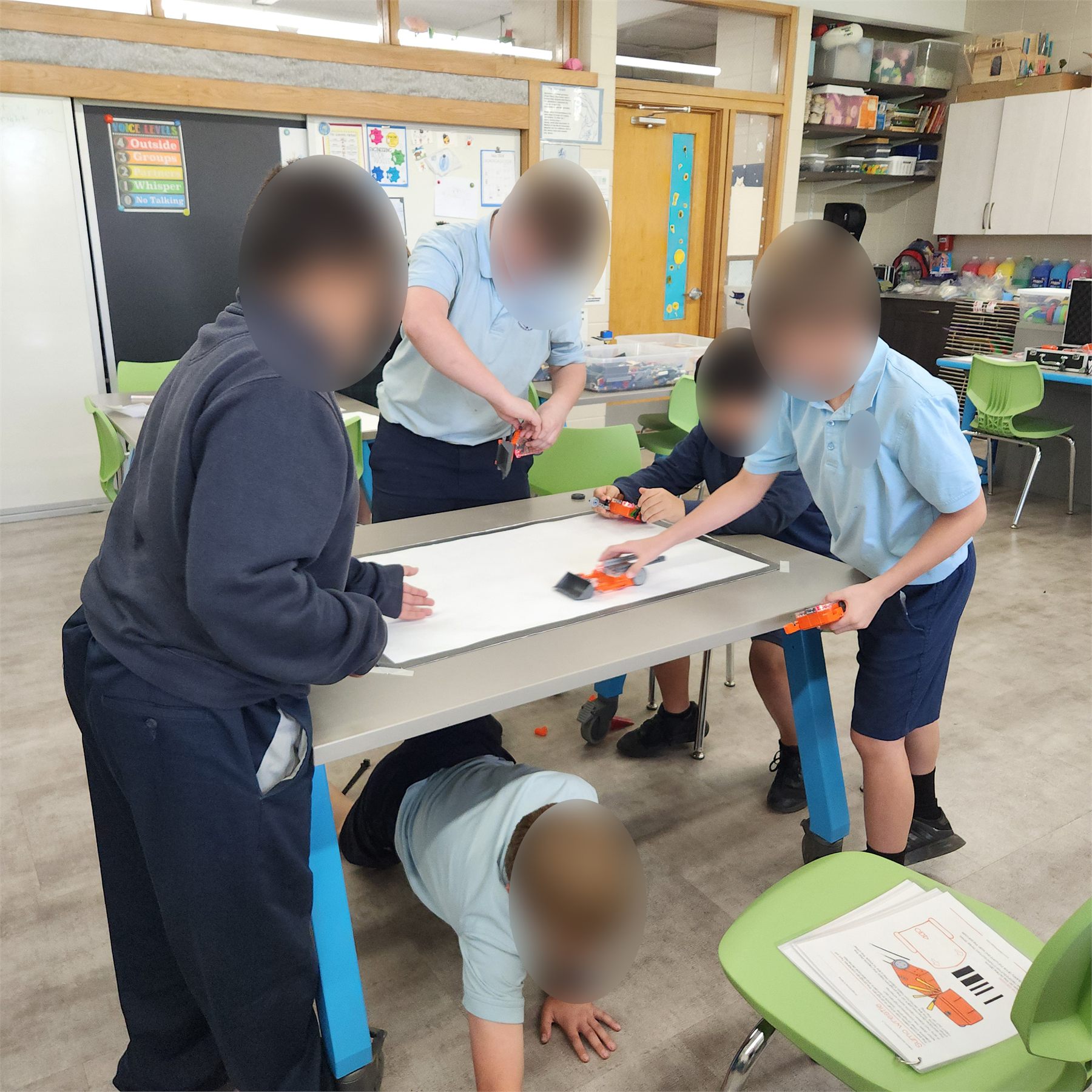 Students racing Edison robots during a classroom challenge