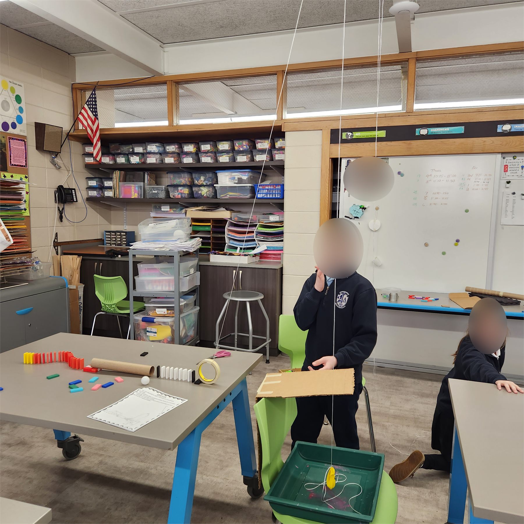 Student working with a ramp-based Rube Goldberg machine